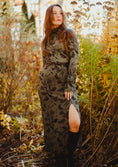 Load image into Gallery viewer, Woman in a patterned dress standing in a forest with autumn foliage