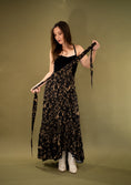 Load image into Gallery viewer, woman wearing a black and gold flowy skirt on a green gold backdrop.