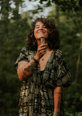 Load image into Gallery viewer, Woman holding a plant in a forest setting