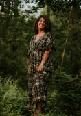 Load image into Gallery viewer, Woman in a patterned dress standing in a forest