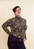 Load image into Gallery viewer, woman wearing a mouse printed turtleneck and blue jeans.