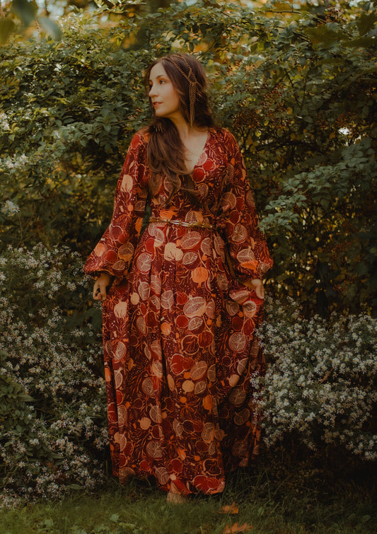 Woman in a floral dress standing in a garden
